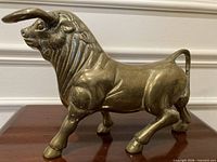 Brass bull statue side view showing full form