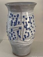 Front and side view of ceramic vase showing glaze pattern and condition