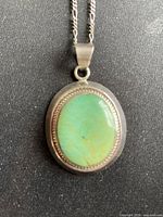 Close-up of pendant front showing turquoise cabochon and sterling setting