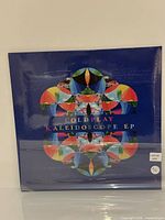 Front view of sealed Coldplay Kaleidoscope EP vinyl record in shrink wrap