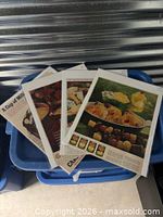 Stack of four sleeved ads on storage bin