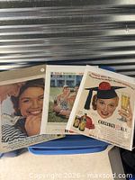 Group photo of three vintage ads on blue chair