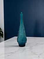 Full view of blue glass decanter on countertop