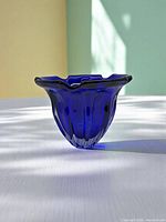 Front view of cobalt blue bowl showing scalloped rim and grooves