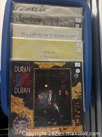 All five album jackets stacked in bin