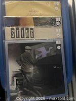 Front covers of the four albums stacked in plastic sleeves