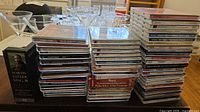Wide view of three stacks of jewel-case CDs and MLK 15-disc box set on table