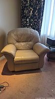 Front view of tan leather recliner chair