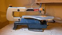 Left side view of Ryobi SC164VS scroll saw on bench
