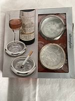 Retail box showing two coasters through window and photo of coasters in use