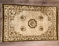 Full view of wool rug showing pattern and fringe
