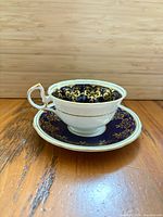 Teacup on saucer showing cobalt blue and gold design