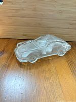 Clear solid glass car paperweight side view