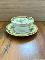 cup and saucer angled view shows pattern, gilding, shape