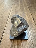 Angled view of metallic mineral on stand