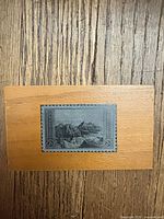 Front view showing stamp and wood plaque surface