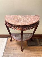 Full front view of console table showing marble top, carved apron, legs and lower shelf