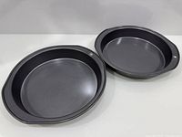 Two gray nonstick pie pans side by side