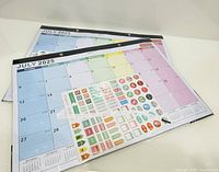 Two views of the 2025 desk pad calendar with sticker sheet on top