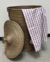 Basket with lid removed showing interior and cloth for scale