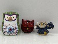 Front view of three owl figurines