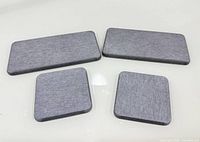 Group shot of two square and two rectangular stone grey pads