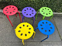All five stools arranged outdoors showing colors and design