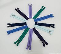Circular arrangement of ten assorted color nylon zippers