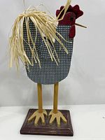 Full view of rooster figurine on base
