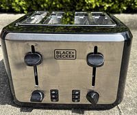 Front view showing Black+Decker logo, dual controls, stainless and black finish