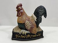 Front view of painted cast iron rooster doorstop