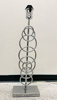 Full view of chrome table lamp showing ring design and base