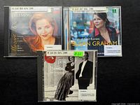 Front covers of three CDs arranged on black background