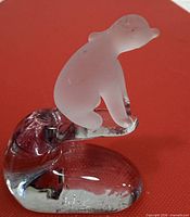 Side profile of frosted glass polar bear on clear glass base