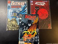 Three bagged Batman comics laid out – issues #444, Batman and Two-Face #25, and Batman #437 Year 3