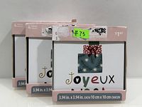 Three sealed pink boxes each labeled “4 pieces” with visible Joyeux Noël coaster design