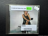 Front of CD jewel case with album art, classification label, and ‘Japan’ sticker