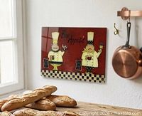 Full view of glass cutting board mounted on wall showing design and shape