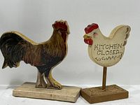Front view of rooster and hen figurines