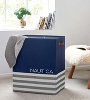 Stock image of assembled blue and grey Nautica hamper in room