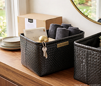 Promo image showing metallic black woven bin staged with contents