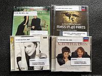 Front covers of four CDs showing titles and library stickers