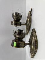 Side view of both sconces mounted on wall showing finish and exposed wires