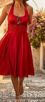 Model wearing red satin halter midi dress outdoors, shows fit and color