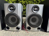 Front view of both Sony SS-CHP27 speakers showing grilles, tweeters, ports