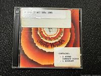 Front of jewel case showing album cover and library stickers