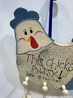 Full view of chicken plaque with hanging eggs
