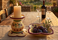Pedestal candle holder with candle and matching dish on table