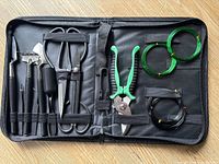 Full kit inside open black zip case on wood floor