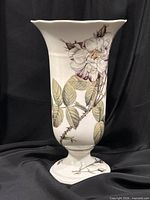Full view of vase front showing wild rose illustration and flared rim